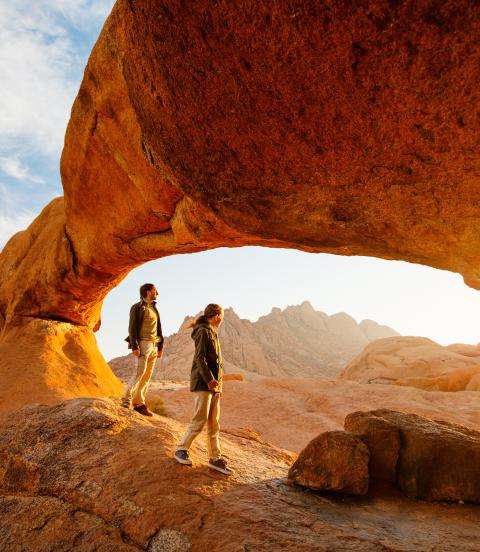 sunrise red rock people hiking