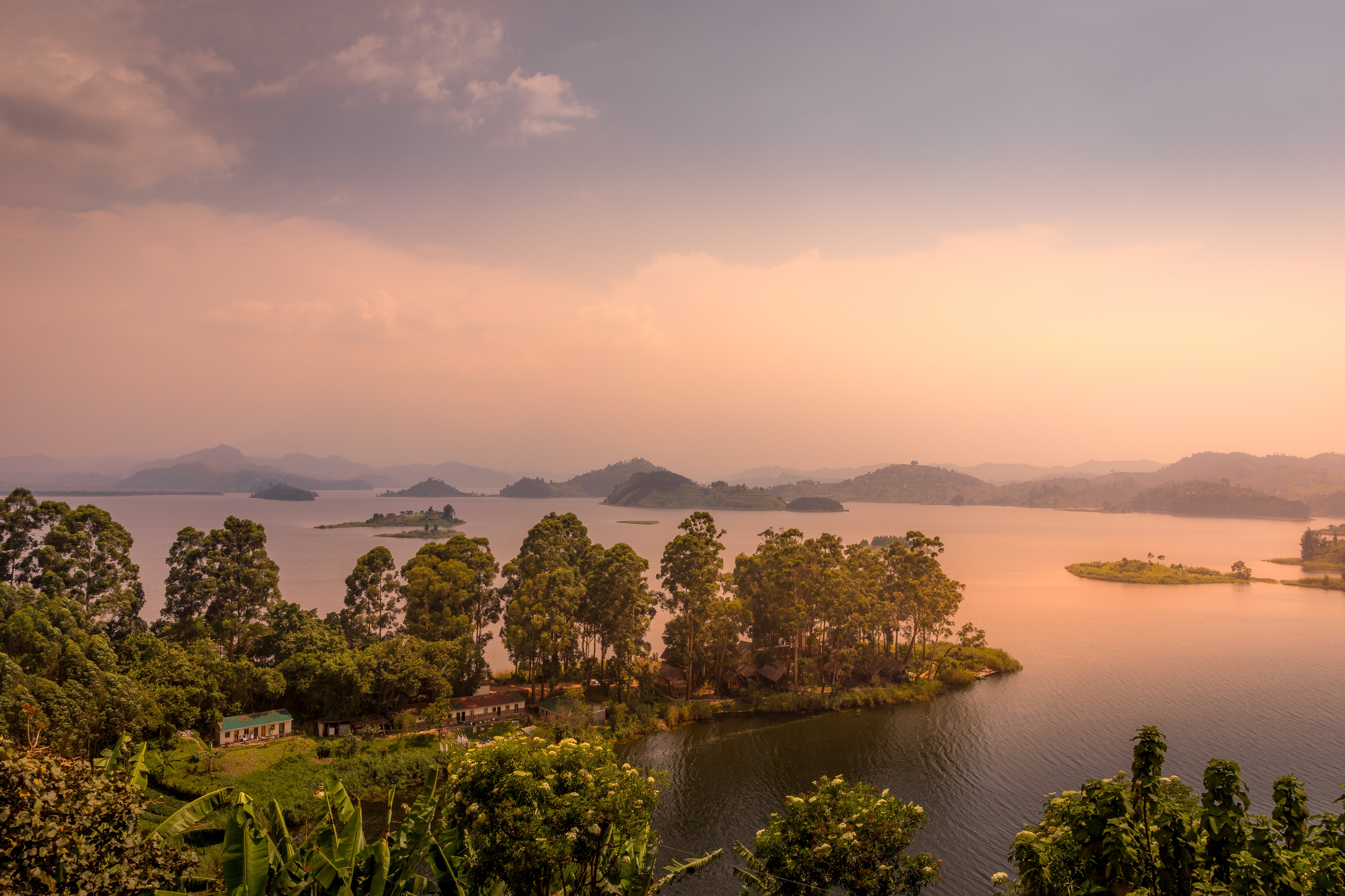 Lake Mutanda at sunset with view on the volcanoes mount Muhavuru and mount Gahinga in East Africa, along the border of Rwanda and Uganda