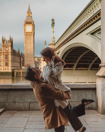 A couple embrace in front of Big Ben in London